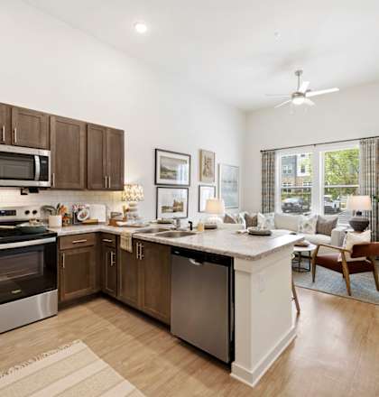 A modern kitchen with wooden cabinets and stainless steel appliances.