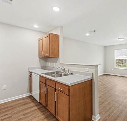 A kitchen with wooden cabinets and a white countertop.