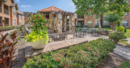 our apartments offer a courtyard with tables and chairs and plants