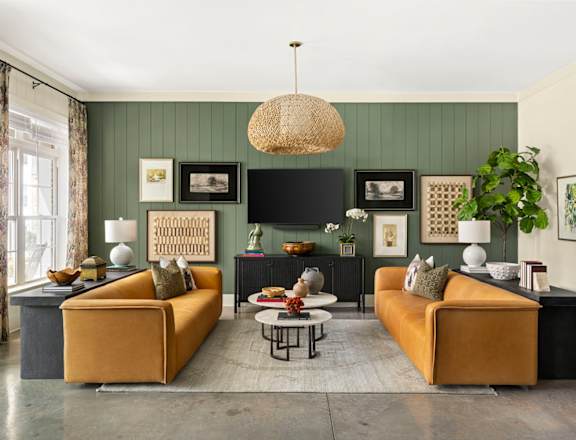 A living room with two yellow sofas and a coffee table.