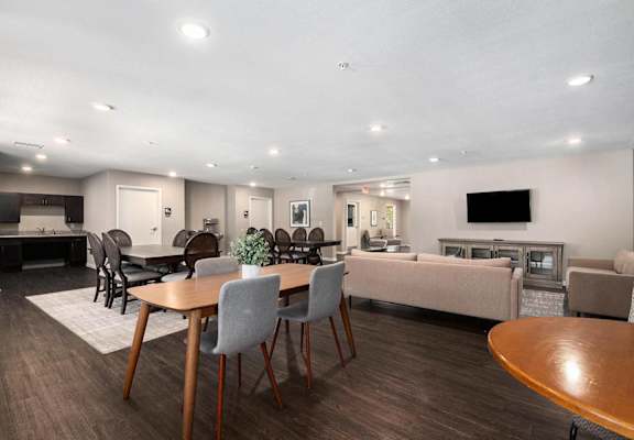 a dining room and living room with a table and chairs