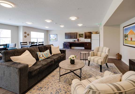 a living room with couches and chairs