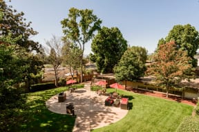 Apartments for Rent in Palo Alto CA - Palo Alto Place - Courtyard Area with BBQ, Tables, Umbrellas, and Couches