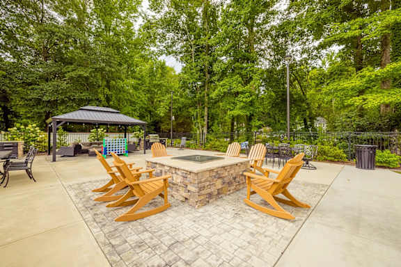 A patio with a fire pit and chairs. at Forest Hills Racquet Club, Augusta, Georgia