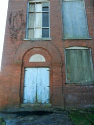 Exterior of the entryway of Converse Mill Lofts before restoration.