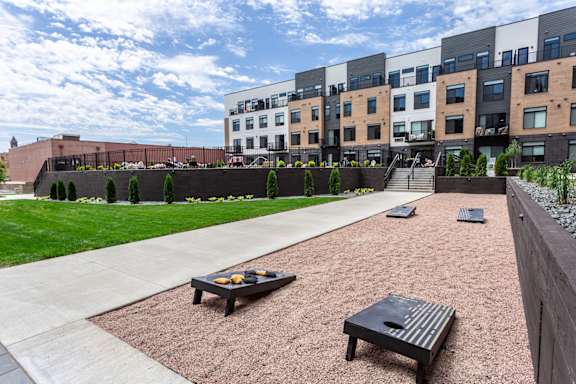 A patio area with a table and chairs in front of a building.