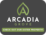 a sign that says arcadia grove check out our sister property