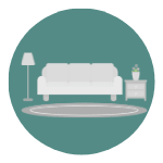 A white sofa sits next to a small table with a vase on it.