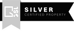 a sign for silvercertified property in front of a tree