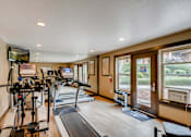 Thumbnail 26 of 34 - Apartments For Rent In Happy Valley, OR - Sunnyside Village - Fitness Center With Cardio Machines, Free Weights, and Full Body Mirror