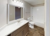 Thumbnail 23 of 26 - Full Bath with white countertops and updated modern lighting