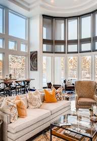 A living room with a large couch and a fireplace.