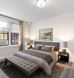 a bedroom with a bed and a large window