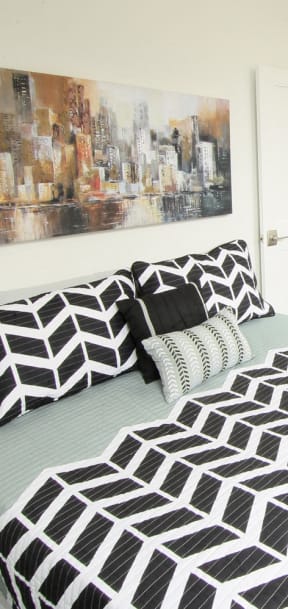 a bedroom with a bed and a desk and a mirror