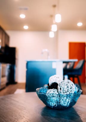 a kitchen and dining room with a table and a bowl of balls