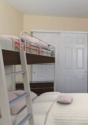 A bedroom with a bunk bed and a carpeted floor.