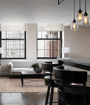 a living room with a couch and a table and chairs