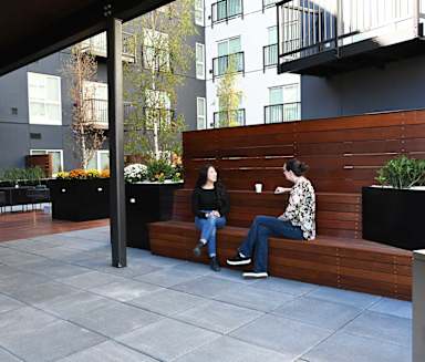 two people sitting on a wooden bench