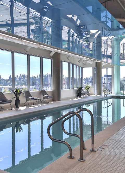 Indoor pool with large glass windows at Soma Towers Bellevue, WA apartments
