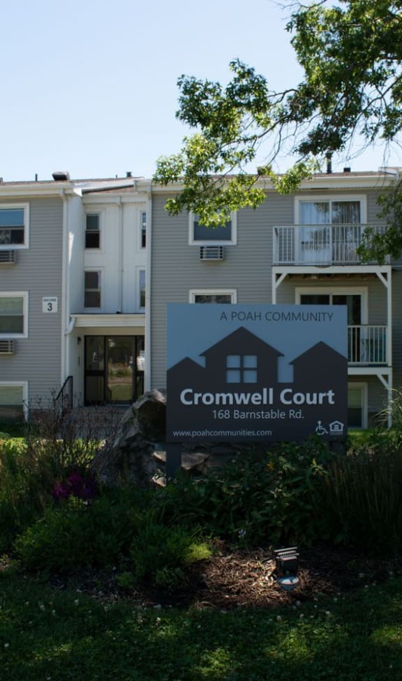 an apartment building with a sign that reads crownwell court