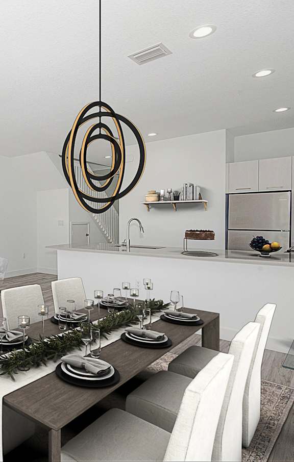 a living room and dining room with a table and chairs
