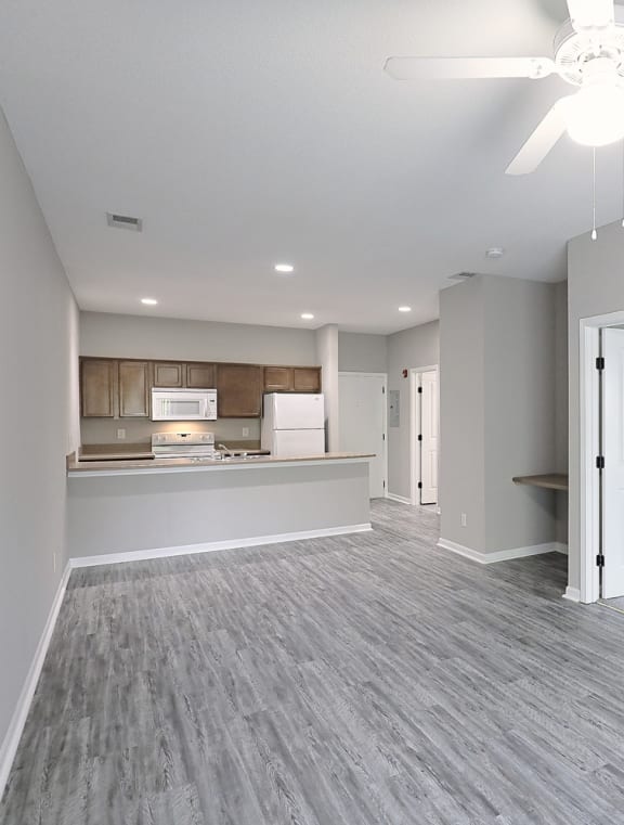 the living room is open to the dining room and kitchen