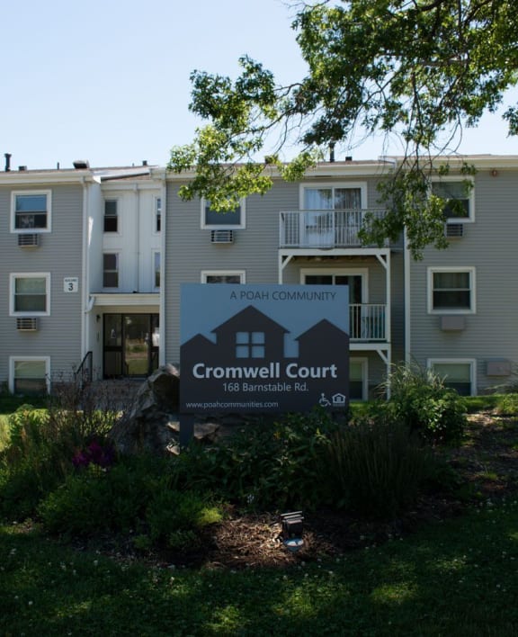 an apartment building with a sign that reads crownwell court