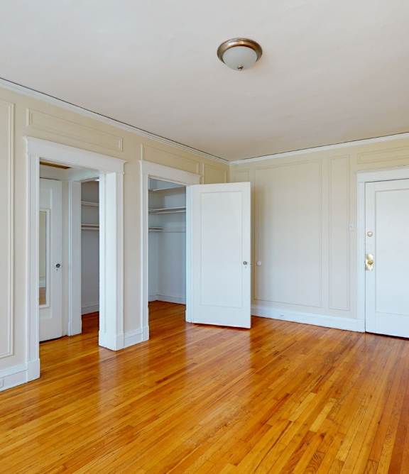 A room with wooden floors and white walls.