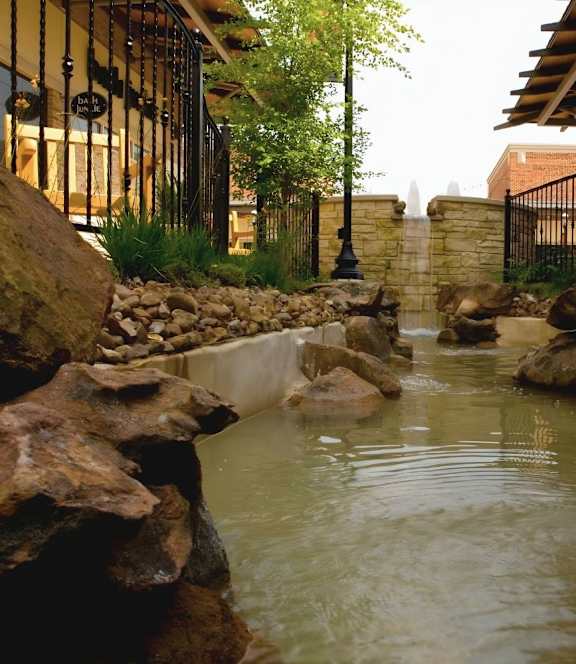 A small waterway with rocks on the sides.