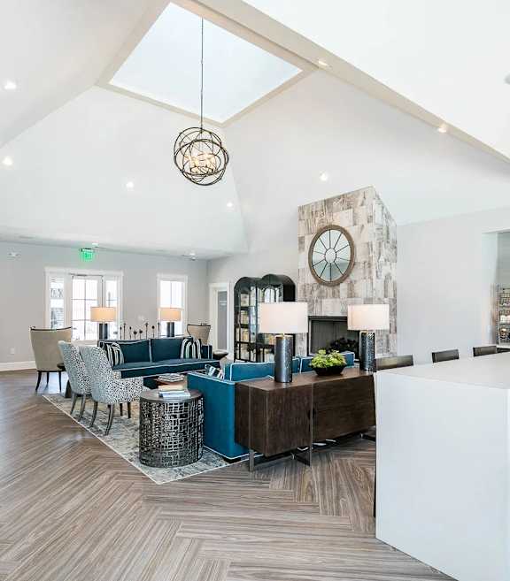 an open kitchen and dining area with a marble counter top