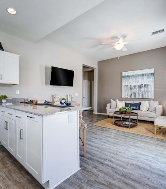 A modern kitchen with white cabinets and stainless steel appliances.