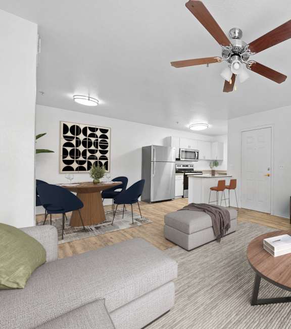 A living room with a grey couch, a wooden coffee table, and a ceiling fan.