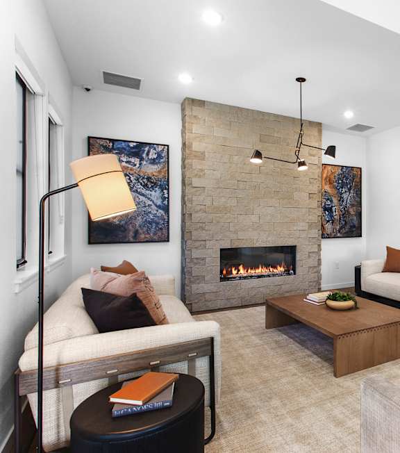 A modern living room with a fireplace and a couch.