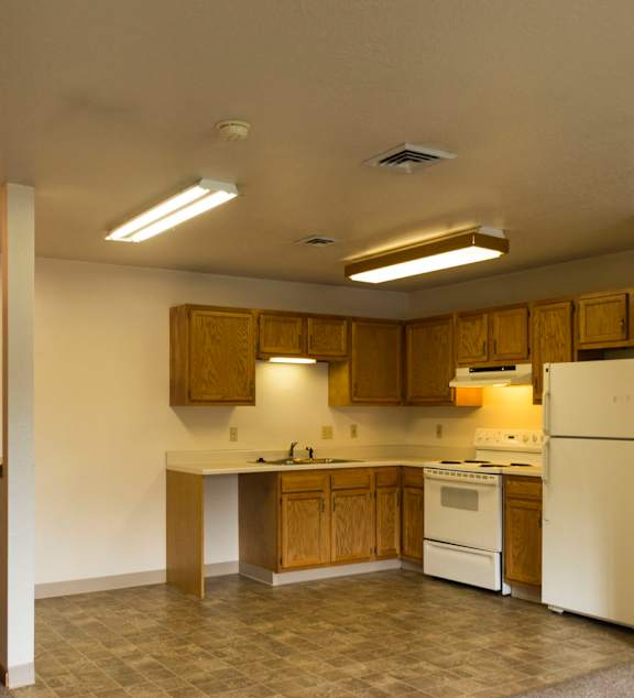 a living room and kitchen with a couch and a table