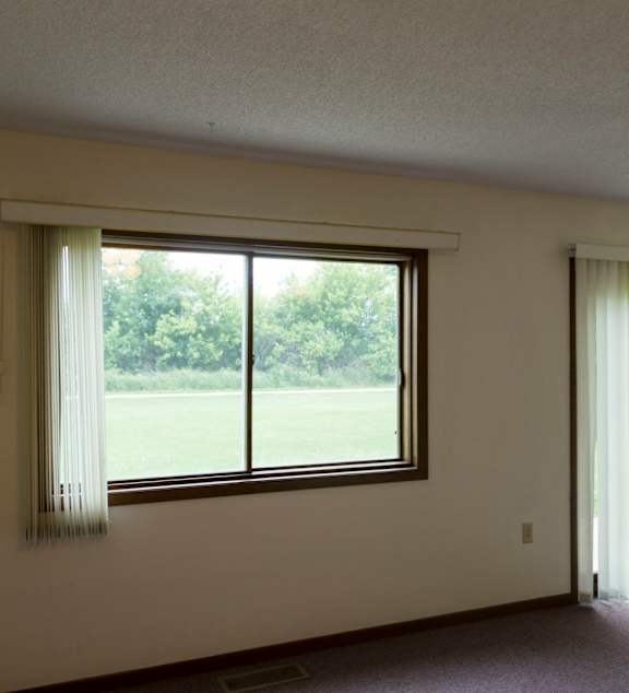 a living room and kitchen with a couch and a table