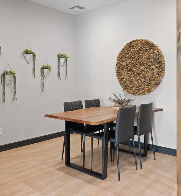 a dining room with a wooden table and black chairs