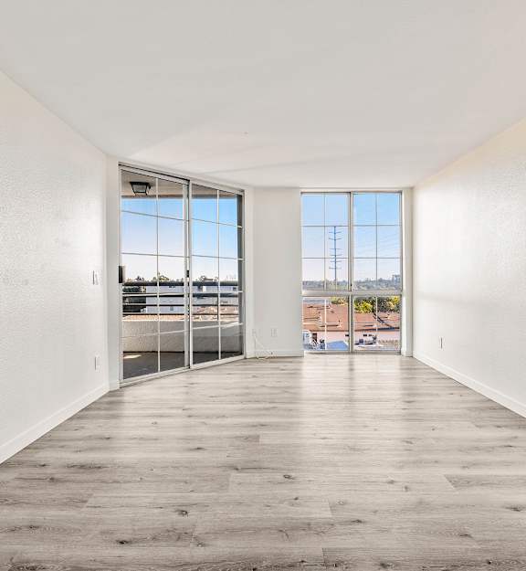 A room with white walls and a wooden floor.