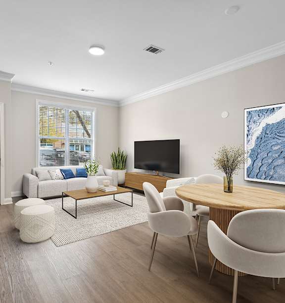 A living room with a sofa, a coffee table, a painting, a ceiling fan, and a bedroom in the background.