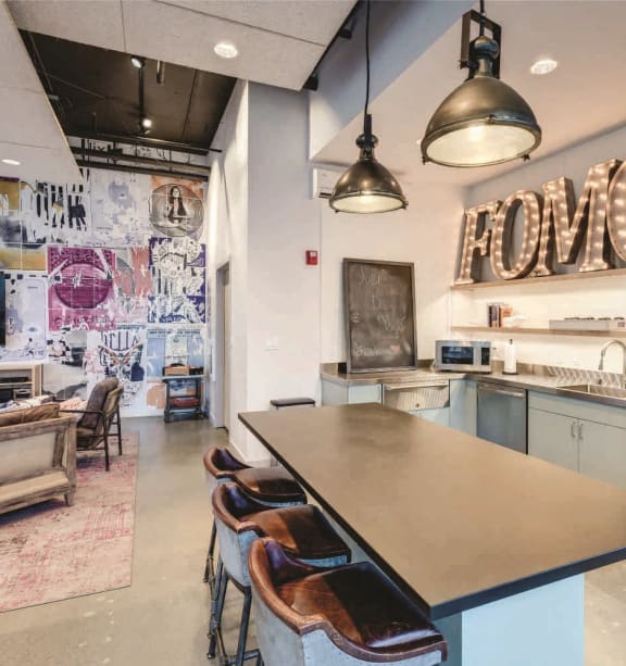 a kitchen with a large island with three stools