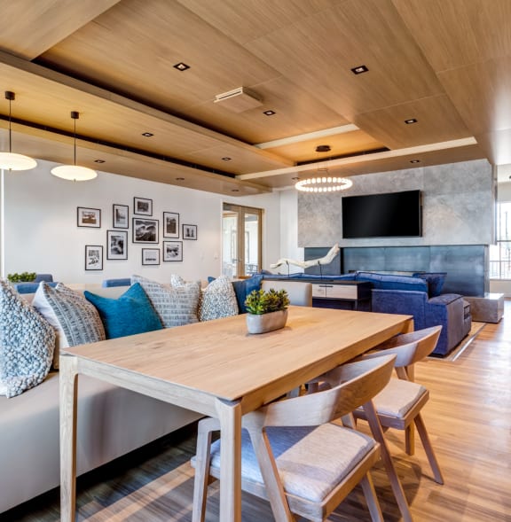 a living room and dining room with couches and a table