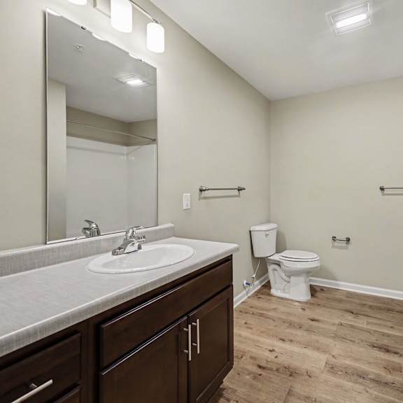 A bathroom with a sink, toilet, and bathtub.