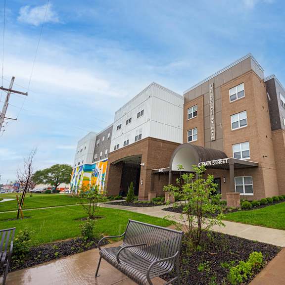 A modern building with a bench in front of it.