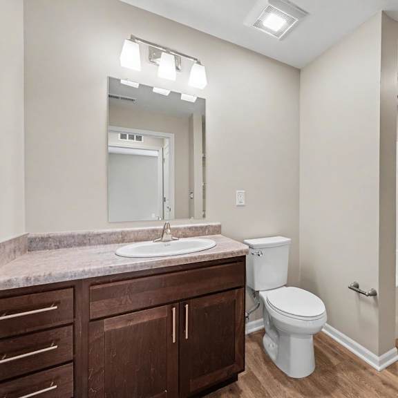 A bathroom with a toilet, sink, and a walk-in shower.
