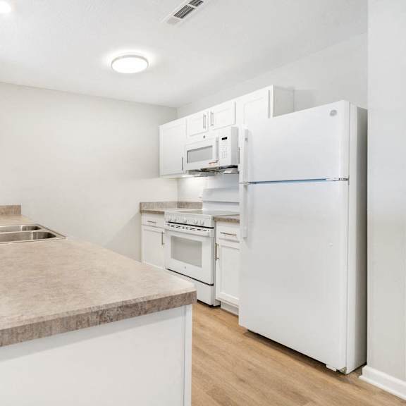 a kitchen with a sink and a refrigerator