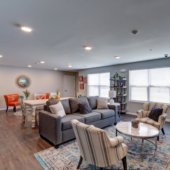 a living room with couches chairs and a table