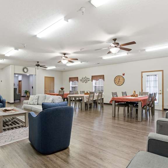 A living room with a dining table and chairs.