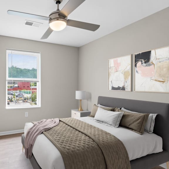 a bedroom with a bed and a ceiling fan