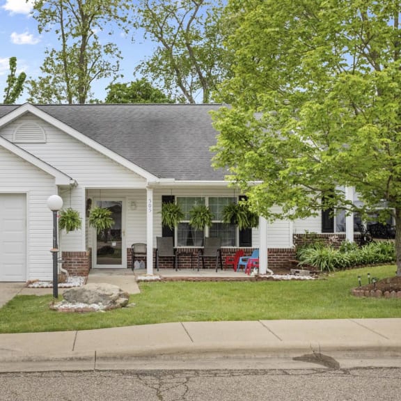 a white house with a lawn and a white garage door