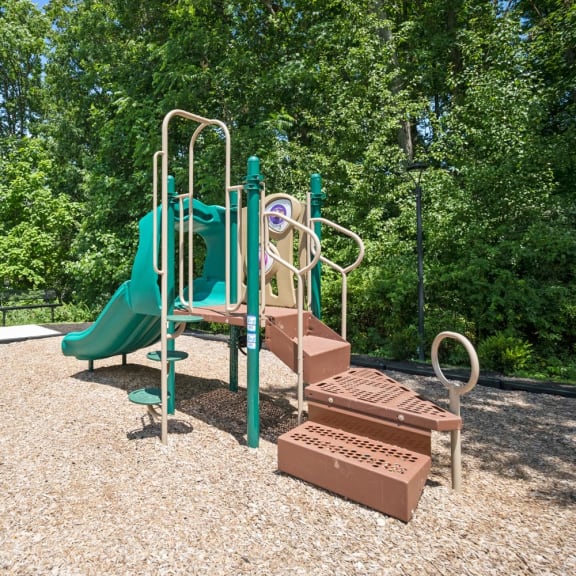 a playground with a slide and a picnic table