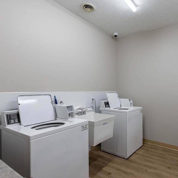 A room with white appliances and a white wall.